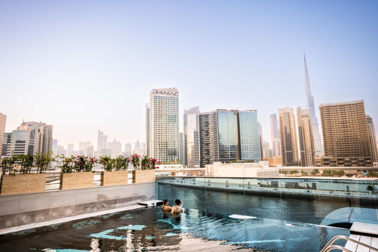 Hyde Hotel Dubai Exterior photo View of the Dubai skyline from the rooftop pool at the Address
